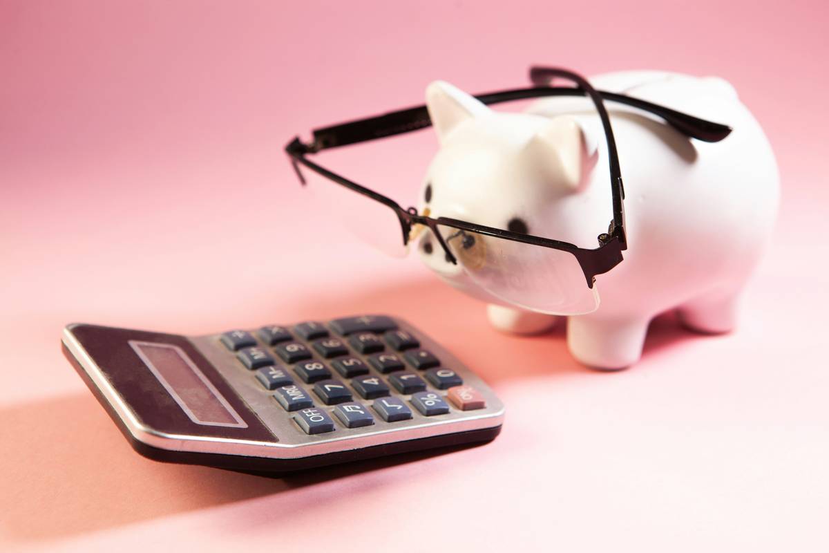 help managing financial budget with sticky notes, calculator, and coffee on a kitchen table